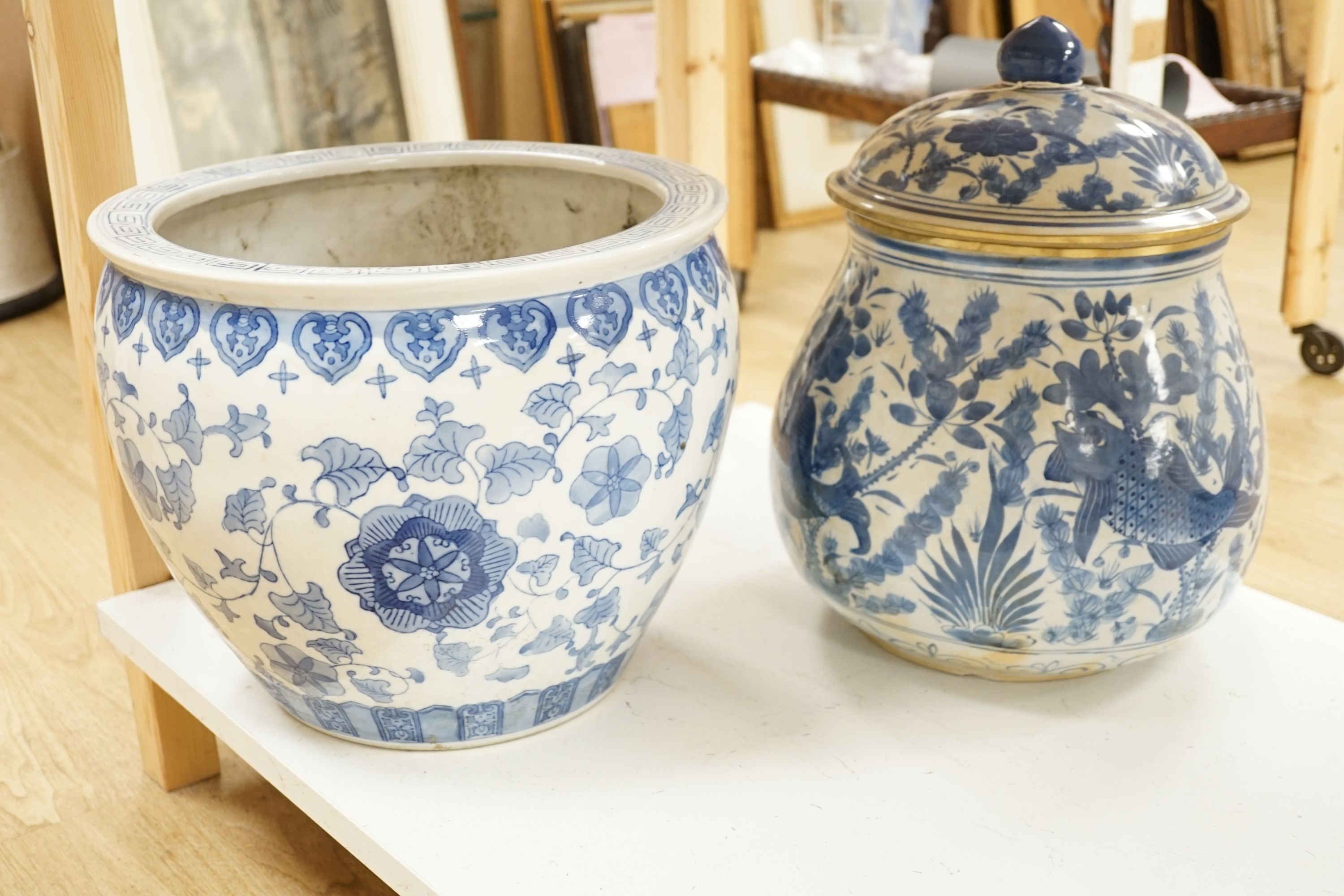 A Chinese blue and white fish bowl and a similar jar and cover, fish bowl 20 cms diameter.